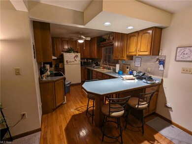 Kitchen featuring electric stove, white refrigerat