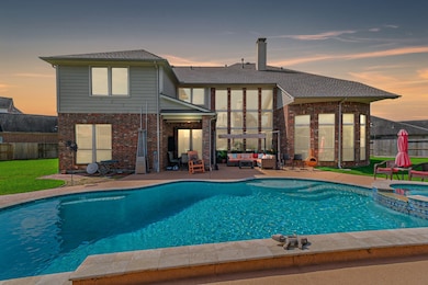 Resort-style backyard oasis featuring a sparkling