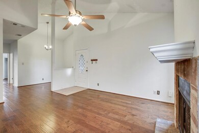 Unfurnished living room with ceiling fan, a brick