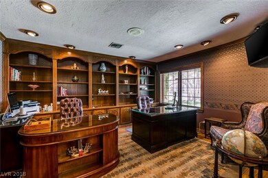 This office has custom wood built-ins.