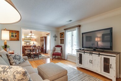 Living room featuring a chandelier, ornamental mol