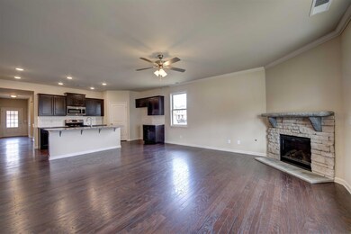 View from eating area into great room.  All photos of a similar home, not of the listed property.