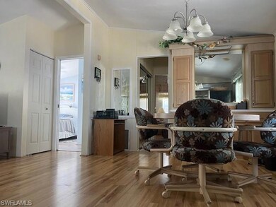 Dining space with an inviting chandelier, crown mo