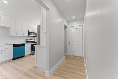 Corridor featuring light wood-type flooring, recessed lighting, and baseboards