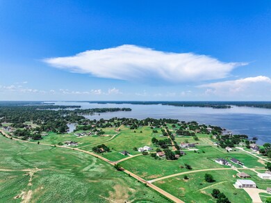 Aerial view of property and surrounding area featuring a nearby body of water