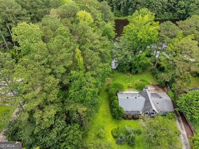 This is a good look at the expanse of property included with the home. The trees to the left are part of the parcel, almost to the neighbor's driveway which is visible here.