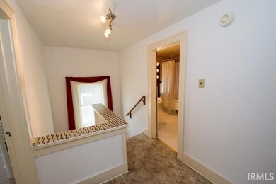 Stairway with landing leading to second floor hall