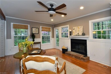 Keeping Room with wood burning fireplace and door to patio.