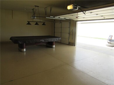The 3 car garage has a neatly painted floor and an