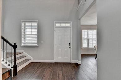 Entrance foyer featuring dark wood finished floors and stairs