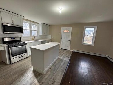 Kitchen with appliances with stainless steel finishes, light countertops, backsplash, and plenty of natural light