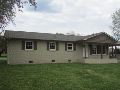 Another view (This house has painted brick. New shutters beautifully coordinate the colors)