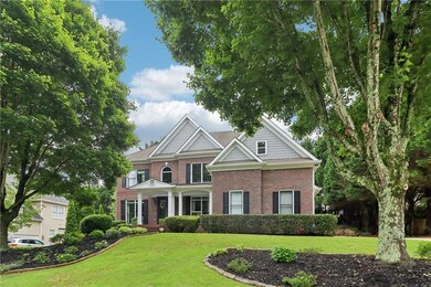View of front of house featuring brick siding and a front lawn