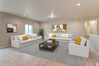 Living room with recessed lighting, a textured ceiling, and light wood finished floors