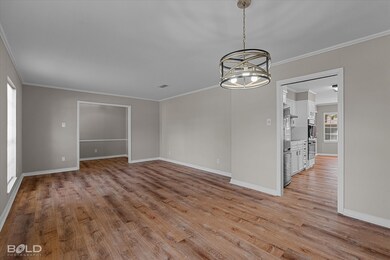 Spare room featuring ornamental molding, a chandelier, and light wood-style flooring
