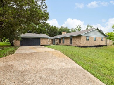 Single story home featuring concrete driveway, br