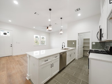 Modern kitchen with elegant lighting fixtures, a s