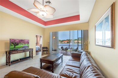 Tiled living room featuring ceiling fan, a raised 