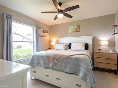 Bedroom featuring multiple windows, light colored 