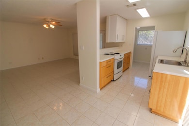 Kitchen with light countertops, light tile patter