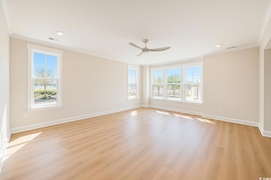 Empty room featuring crown molding, light wood-style flooring, a ceiling fan, and recessed lighting