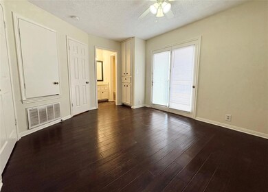 Empty room featuring dark wood finished floors, b