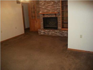 Living room with wood burning fireplace.
