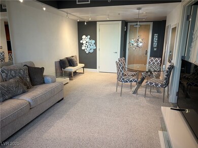 Carpeted living room with rail lighting, baseboard