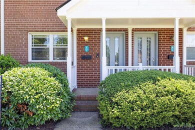 Doorway to property featuring brick siding and a p