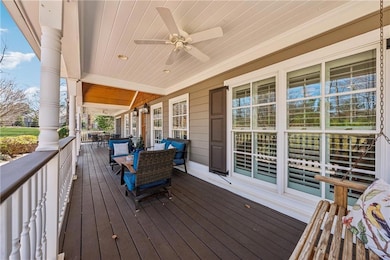 Wooden deck featuring a ceiling fan