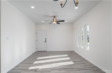 Spare room with baseboards, light wood-type flooring, and recessed lighting