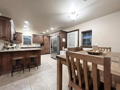 Dining space with light tile patterned flooring