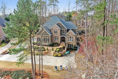 Craftsman-style home with a chimney, stone siding, and roof with shingles