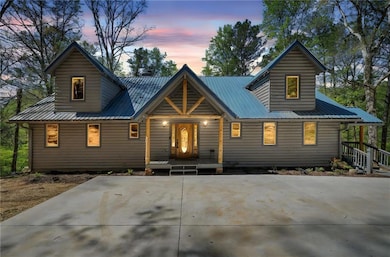 Chalet / cabin with metal roof, concrete driveway,