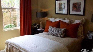 Main floor bedroom with view of side yard lush pla