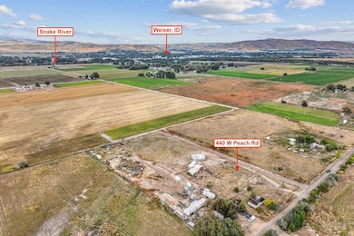 Aerial view of property and surrounding area featuring a mountain backdrop and rural landscape