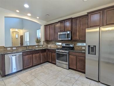 Kitchen featuring a sink, tasteful backsplash, an