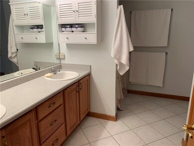 Large Master bathroom, features Jetted bathtub, standing shower his and her sinks, and a shut out area to the toilet.