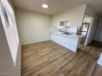 Kitchen with freestanding refrigerator, light coun