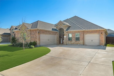 French country style house with a garage, stone siding, and roof with shingles