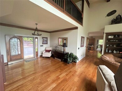 View of Front Entry Foyer from the Great Room (with open Loft above, Kitchen/Dining/Screened Porch beyond).