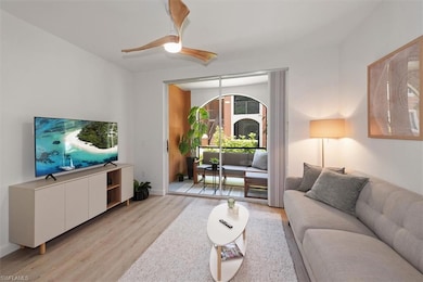 Living room with light wood finished floors and a ceiling fan