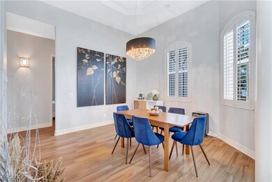 Dining area with wood finished floors and a chandelier