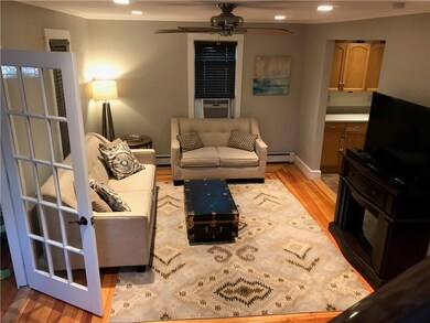 Living room w/ beautiful hardwoods open to kitchen