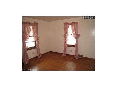 Bedroom 2 with hardwood floors.