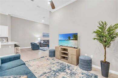 Living room with light tile patterned floors, ceil