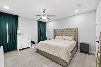 Bedroom with a ceiling fan, light wood-style floors, and recessed lighting