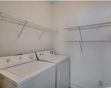 Laundry area featuring baseboards and washing machine and dryer