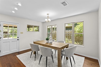 Dining room featuring a chandelier and dark wood 