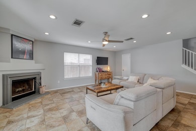 Living room with recessed lighting, a fireplace w